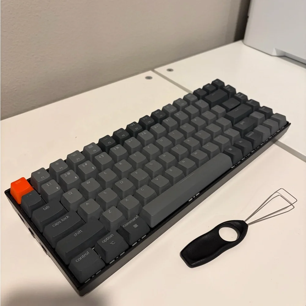 Compact Gray Mechanical Keyboard with Orange Accent